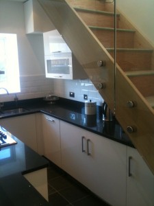 Modern Kitchen with glass staircase