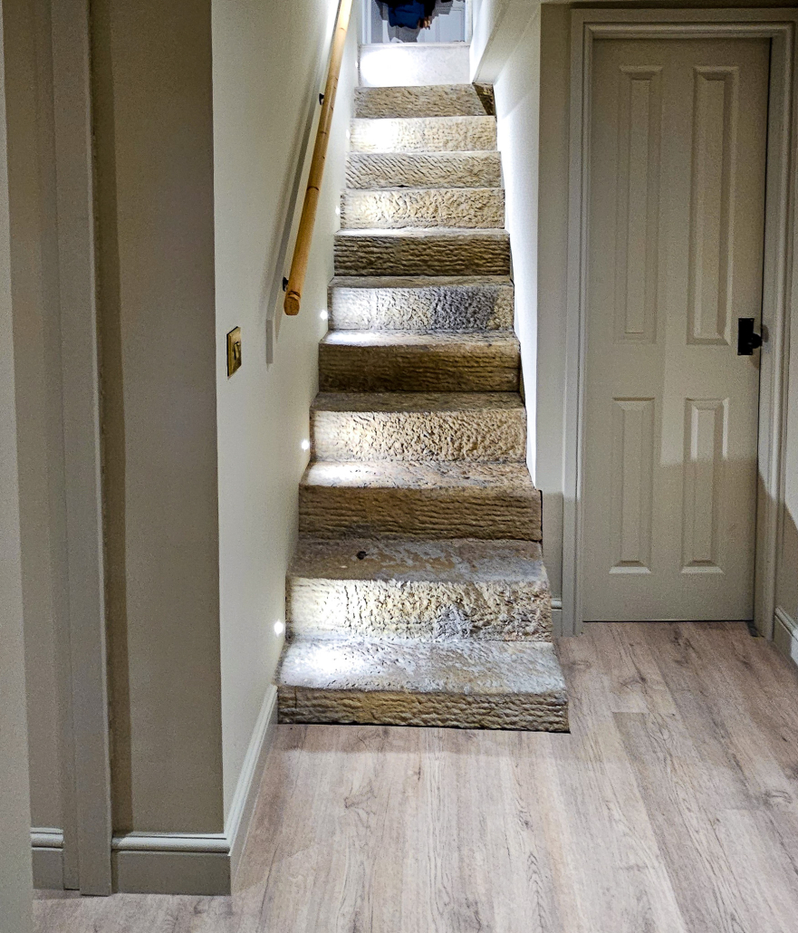 Stone Basement stairs lit Lit stone stairs of a basement conversion in Saddleworth