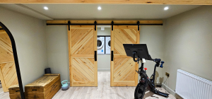 Barn doors in a basement conversion, hiding the washing machine